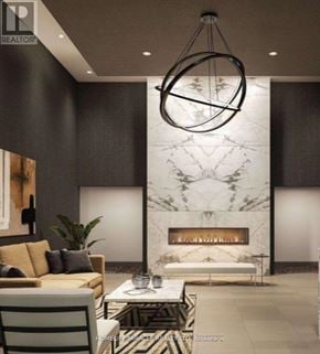 Milton (Walker) condo for rent - A modern living room with a fireplace and a large circular light fixture.