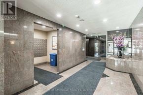 Brampton (Fletcher's Creek South) condo for rent - A lobby with a blue trash can and a marble floor.