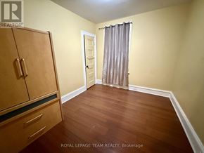 Ottawa apartment for rent - A room with a wooden floor and a brown cabinet.