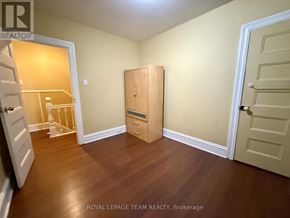Ottawa apartment for rent - A room with a wooden floor and a white door.