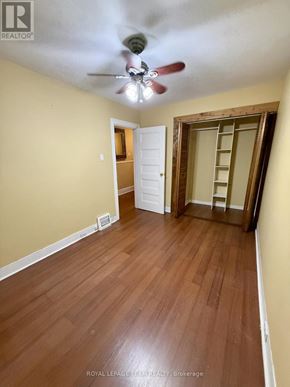 Ottawa apartment for rent - A room with a ceiling fan and wooden flooring.