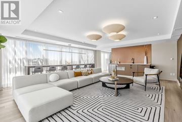 Toronto (Yonge-Eglinton) condo for rent - A modern living room with a large sectional sofa and a coffee table.