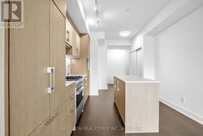 Toronto (Yonge-Eglinton) condo for rent - A modern kitchen with wooden cabinets and a stove top oven.