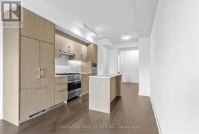 Toronto (Yonge-Eglinton) condo for rent - A modern kitchen with wooden cabinets and appliances.