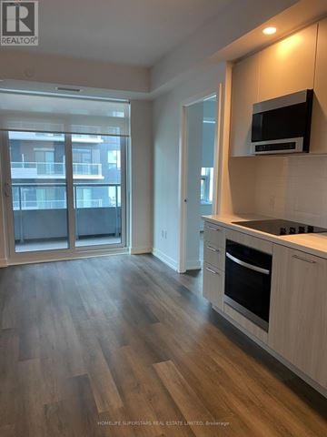 Vaughan (Vaughan Corporate Centre) condo for rent - A kitchen with wooden floors and a microwave on the counter.