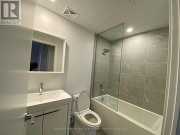 Vaughan (Vaughan Corporate Centre) condo for rent - A bathroom with a toilet, sink, and shower.