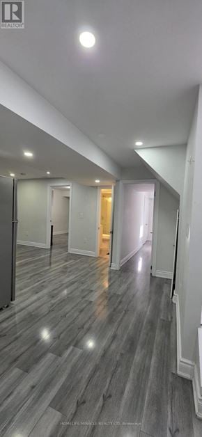 Brampton (Northwood Park) apartment for rent - A spacious room with wooden flooring and white walls.