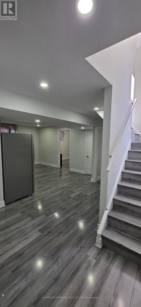 Brampton (Northwood Park) apartment for rent - A spacious room with wooden flooring and a staircase.