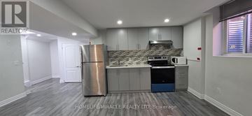 Brampton (Northwood Park) apartment for rent - A kitchen with a stainless steel refrigerator and a blue trash bin.