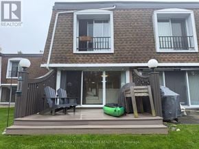 Ramara townhouse for rent - A house with a deck and patio furniture is for sale.