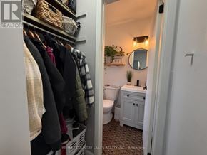 Ramara townhouse for rent - A white closet with clothes hanging and a toilet in the background.