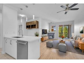 Surrey apartment for rent - A modern kitchen with a large island and a dining area with a view of the backyard.