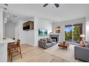 Surrey apartment for rent - A living room with a grey couch, a wooden chair, a coffee table, and a painting on the wall.
