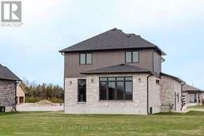 Saugeen Shores apartment for rent - A house with a grey roof and a sign that says RE/MAX Land Exchange-Ltd, Brokerage.