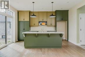 Saugeen Shores apartment for rent - A kitchen with green cabinets and a white counter.