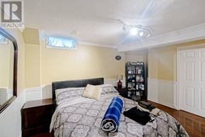 Brampton (Fletcher's West) apartment for rent - A bedroom with a bed, nightstand, and a bookshelf.