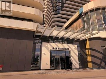 Vaughan (Vaughan Corporate Centre) condo for rent - A building with a sign that says "3-28 Interchange" in front of it.