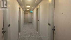 Vaughan (Vaughan Corporate Centre) condo for rent - A long hallway with doors on both sides and a tiled floor.