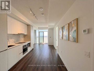 Vaughan (Vaughan Corporate Centre) condo for rent - A spacious kitchen with white cabinets and a marble countertop.
