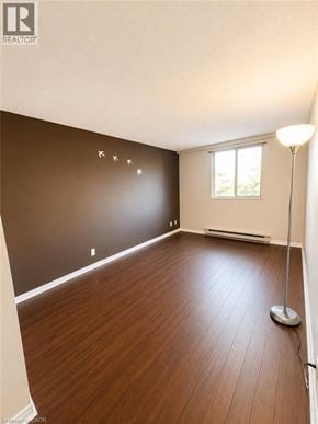 Kitchener condo for rent - A room with wooden flooring and a window.