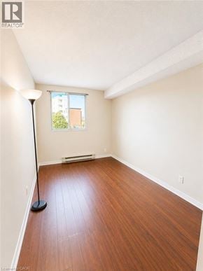 Kitchener condo for rent - A room with wooden floors and a window.