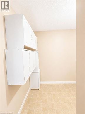 Kitchener condo for rent - A room with a white cabinet and a white trash can.