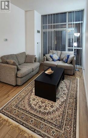 Toronto (Willowdale East) condo for rent - A living room with a rug, a couch, and a coffee table.