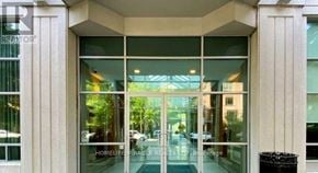 Toronto (Willowdale East) condo for rent - The image shows the front of a building with a glass door entrance and a sign that reads "HOMELIFE Miracle Retail".
