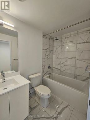 Toronto (Willowdale East) condo for rent - A white bathroom with marble tiles on the walls.