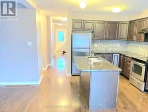 Oshawa (Pinecrest) apartment for rent - A kitchen with a granite countertop and stainless steel appliances.