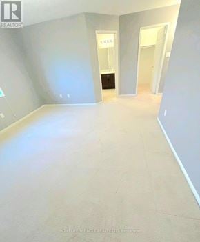 Oshawa (Pinecrest) apartment for rent - A room with a white wall and a doorway leading to another room.