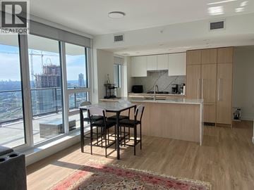 Burnaby apartment for rent - A modern kitchen with a dining table and chairs.