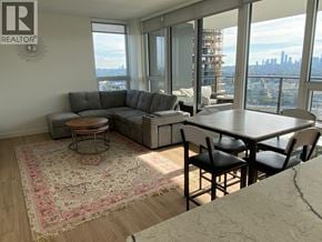 Burnaby apartment for rent - A living room with a view of the city skyline.