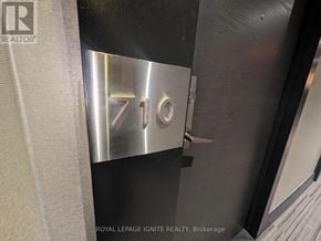 Toronto (Mimico) condo for rent - A metallic sign with the number 710 is mounted on a wall.
