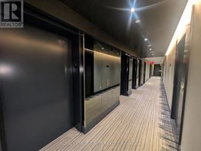 Toronto (Mimico) condo for rent - A long hallway with doors on both sides and a light on the ceiling.