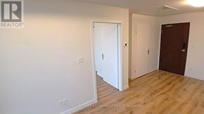 Kitchener condo for rent - A room with a white door and a brown door.
