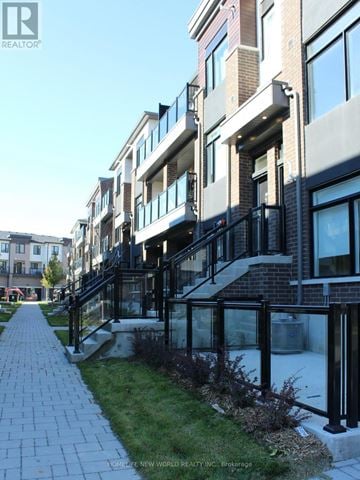 Pickering (Duffin Heights) townhouse for rent - A building with a balcony and a walkway in front of it.
