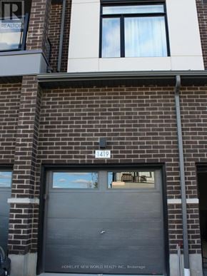 Pickering (Duffin Heights) townhouse for rent - A brick building with a black garage door and a sign that says HomeLife New World Realty Inc. Brokerage.