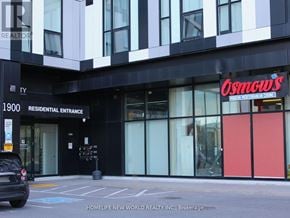 Oshawa (Samac) condo for rent - A black and white building with a red sign that says "Osmosis".