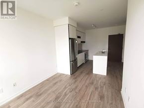 Mississauga (City Centre) condo for rent - A kitchen area with a refrigerator, oven, and microwave.