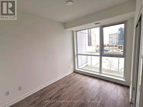 Mississauga (City Centre) condo for rent - A room with a large window and wooden flooring.
