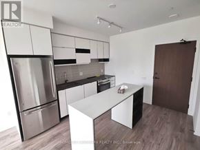 Mississauga (City Centre) condo for rent - A modern kitchen with stainless steel appliances and white cabinetry.