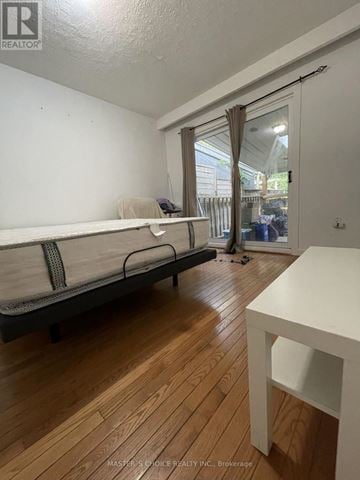 Aurora (Aurora Highlands) apartment for rent - A bedroom with a bed, a table, and a window with curtains.