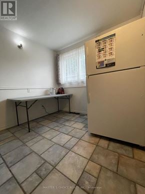 Aurora (Aurora Highlands) apartment for rent - A kitchen with a white fridge and a table with chairs.
