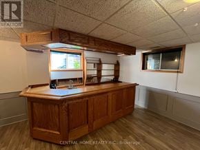 Georgina (Keswick South) apartment for rent - A wooden reception desk with a window above it in a room with white walls.