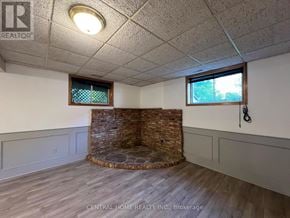 Georgina (Keswick South) apartment for rent - A room with a stone fireplace and wood flooring.