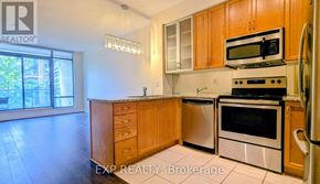 Toronto (Annex) condo for rent - A kitchen with wooden cabinets and stainless steel appliances.