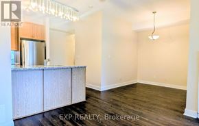 Toronto (Annex) condo for rent - A kitchen area with wooden cabinets and a stainless steel refrigerator.