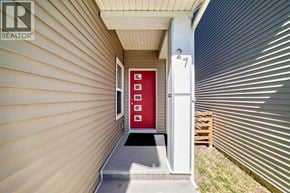 Calgary apartment for rent - A red door is on the side of a house.