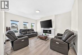 Calgary apartment for rent - A living room with a grey sofa set and a television.